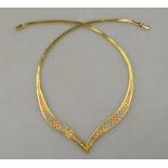 A three-coloured gold mesh V shaped necklace,