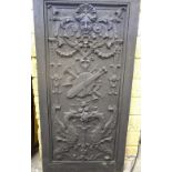 A cast iron panel, with relief mask, scr