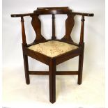 A George III mahogany corner chair with