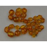 A row of amber beads on chain (broken)