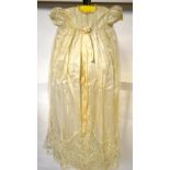 An ivory satin Christening robe overlaid with floral needle-run lace,