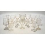 A collection of vine etched wine glasses to/w four liquor glasses etched with zodiac signs,