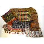 A collection of antique and other Indonesian sarongs including Ikat examples and other gilded