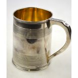 A George III silver mug of tapering cylindrical form with banded decoration,