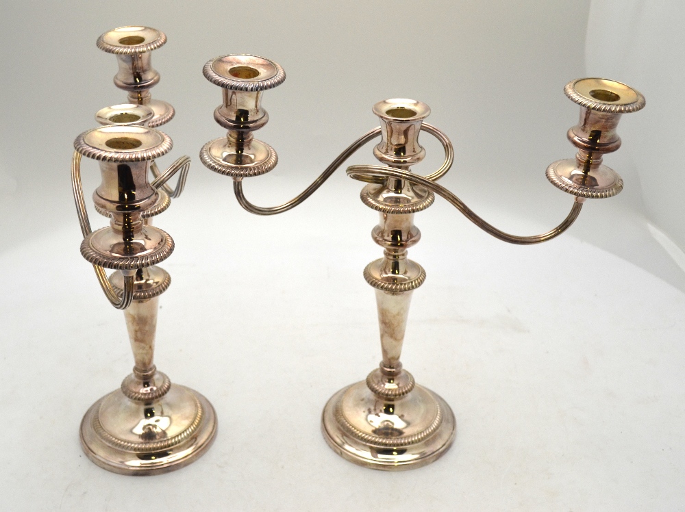A pair of electroplated baluster candelabra with twin branches,