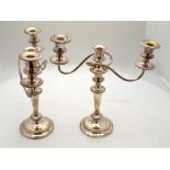 A pair of electroplated baluster candelabra with twin branches,