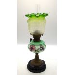 A late Victorian oil lamp with floral etched green glass shade,