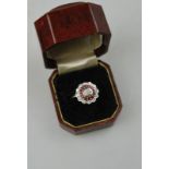 A ruby and diamond three-row cluster ring,