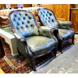 A pair of Victorian mahogany framed button backed leather salon armchairs raised on turned tapering