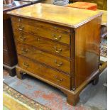 A George III mahogany chest of four long graduated drawers beneath a full width brush slide,