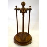 A walnut revolving cue stand for nineteen billiard cues, raised on bun feet,