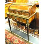 A late 19th century French Empire style brass mounted fruitwood cylinder top writing table with