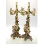 A pair of continental porcelain four branch candelabra,