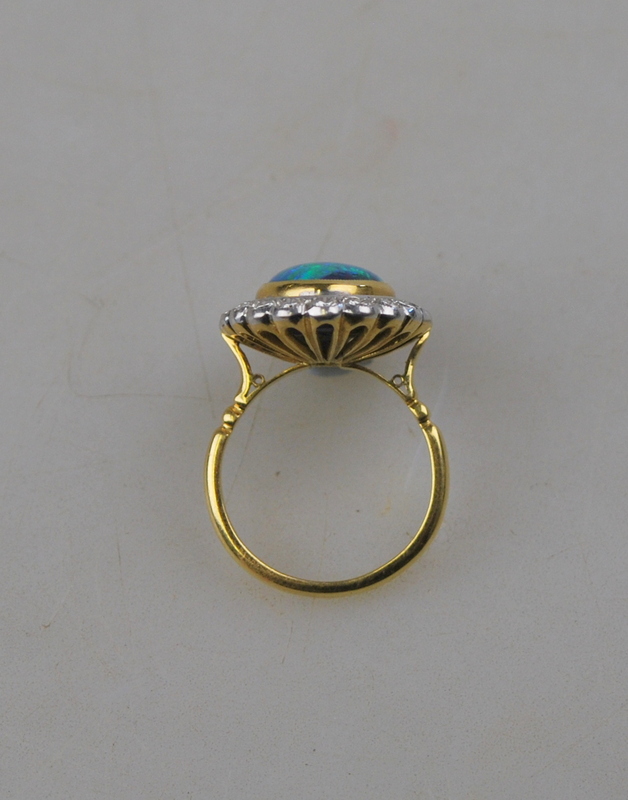 An oval black opal ring having brilliant cut diamonds around, in open basket style setting, - Image 2 of 4