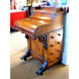 A Victorian burr walnut piano top davenport with rise and fall stationary store over a fitted