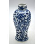 A Chinese Blue and white baluster vase decorated with dragons amidst flowers and foliage,