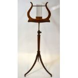 A walnut lyre-form rise and fall tripod music stand,