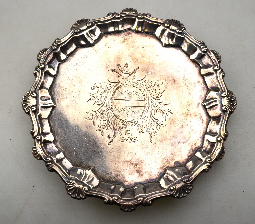 A George III silver visiting-card salver with shell and scroll pie-crust rim and engraved arms,
