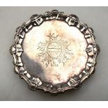 A George III silver visiting-card salver with shell and scroll pie-crust rim and engraved arms,