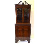 A 19th century oak two part corner cabinet in the Chippendale manner,