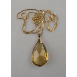 A faceted citrine drop, yellow metal set, setting stamped 9ct on box link gold chain stamped 375,