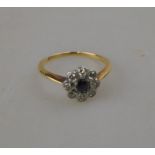 A sapphire and diamond daisy style cluster ring,