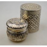 An Indian low-grade white metal cylindrical cigarette box and cover with floral and foliate chased