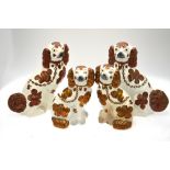 Two pairs of Victorian fireside spaniels with copper lustre decoration,