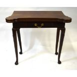 An antique mahogany card table, the shaped fold over baize lined top over a frieze drawer,