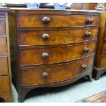 A George III mahogany bow front chest of four long graduated drawers with oversize turned pulls,
