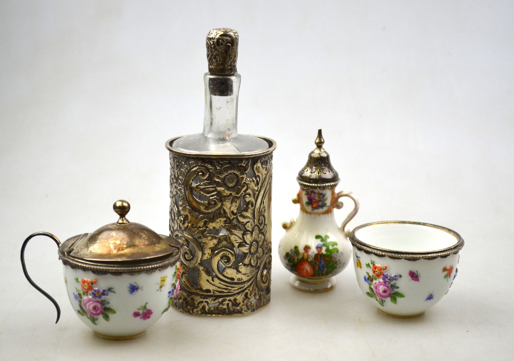 A 19th century Meissen white-metal salt and mustard pair embossed and printed with flowers and