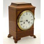 An Edwardian satinwood mantle clock with eight day drum movement with enamelled dial,