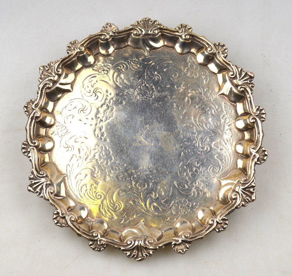 A William IV silver letter salver with shell and scroll rim, engraved decoration and shell feet, A.