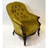 A late 19th century walnut framed button upholstered armchair raised on cabriole front legs