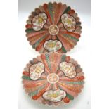 A pair of Japanese polychrome dishes, each one decorated with panels depicting tigers,