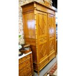 An unusual Continental pine and faux bamboo three piece bedroom suite comprising an armoire with