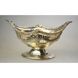 A silver Adam-style bonbon dish of navette form, the pierced sides embossed with garlands,