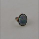 An Arts & Crafts single stone black opal ring,