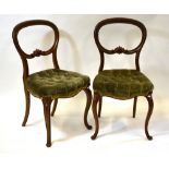 A pair of Victorian walnut framed buttoned seat salon side chairs (2)