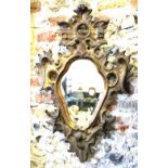 An 18th/19th century Italianate carved giltwood and composite wall mirror,