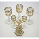 Three sherry/port glasses with octagonal facetted bowls, long facetted stems on circular plain feet,