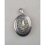 An antique silver locket having monogram at back