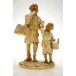 A Japanese carved ivory sectional group of a street vendor with his son,