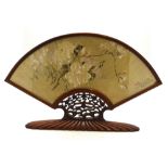 A Chinese gilded paper fan painted with tree branches in blossom,