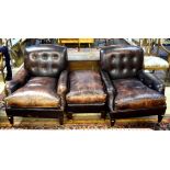 George Smith - a pair of buttoned patinated brown leather easy armchairs in the Howard style to/w a