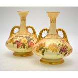 A pair of Royal Worcester blush ground twin handle vases decorated with floral sprays, shape 1747,