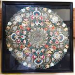 A Victorian framed and glazed circular floral and foliate embroidered panel in hues of pale