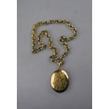 A Victorian oval yellow gold locket having applied textured monogram on a cable style chain,