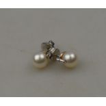 A pair of cultured pearl and eight cut diamond stud earrings,
