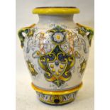 A large Italian majolica oil jar having strap handles, painted in the traditional style with cupids,